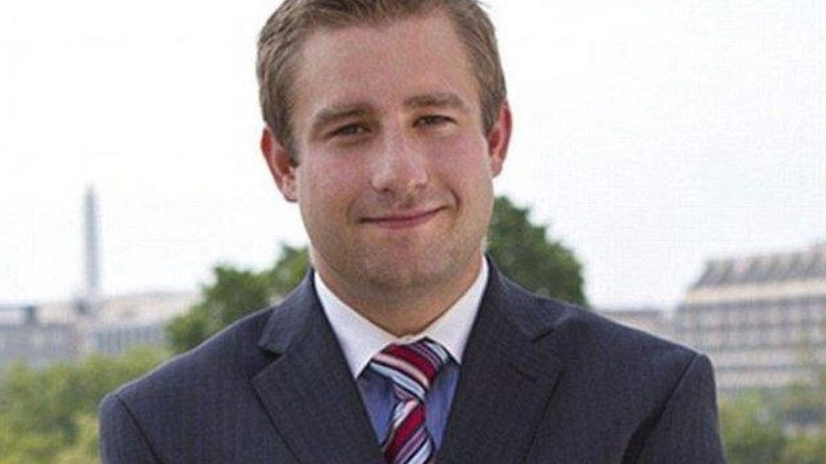 Professional young man in a suit smiling outdoors with a blurred cityscape background, representing confidence and professionalism. Professional young man in a suit smiling outdoors with a blurred cityscape background, representing confidence and professionalism.