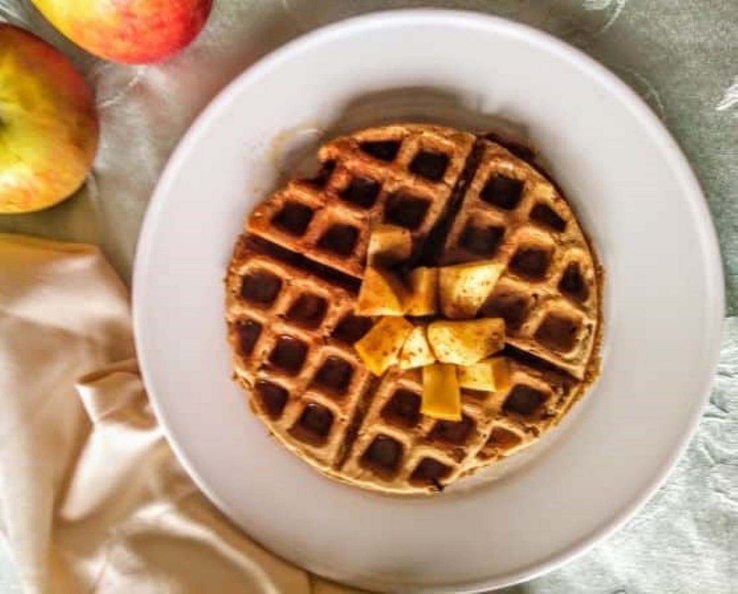 waffle topped with chopped apples.