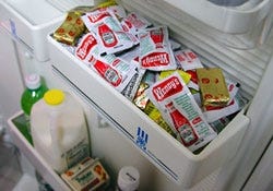 A drawer in Turnbee's refrigerator overflows with excess restaurant condiments.