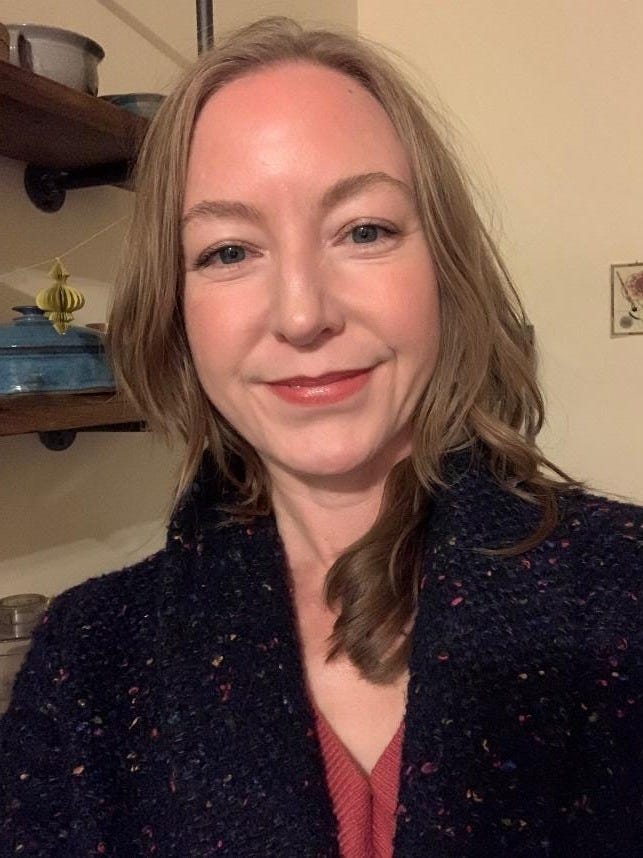 A person smiling at the camera

Description automatically generated