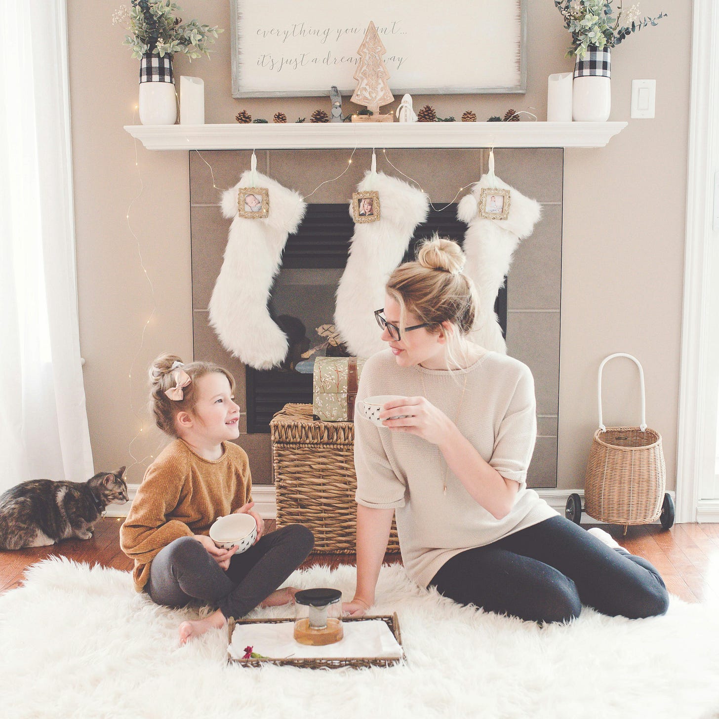 A girl and woman having tea together.