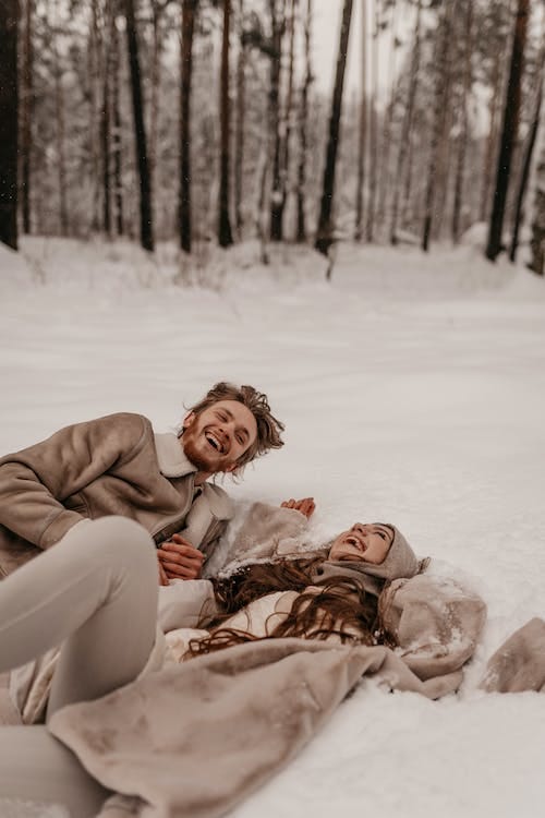 Free Couple Laying in Snow and Laughing Stock Photo Free Couple Laying in Snow and Laughing Stock Photo