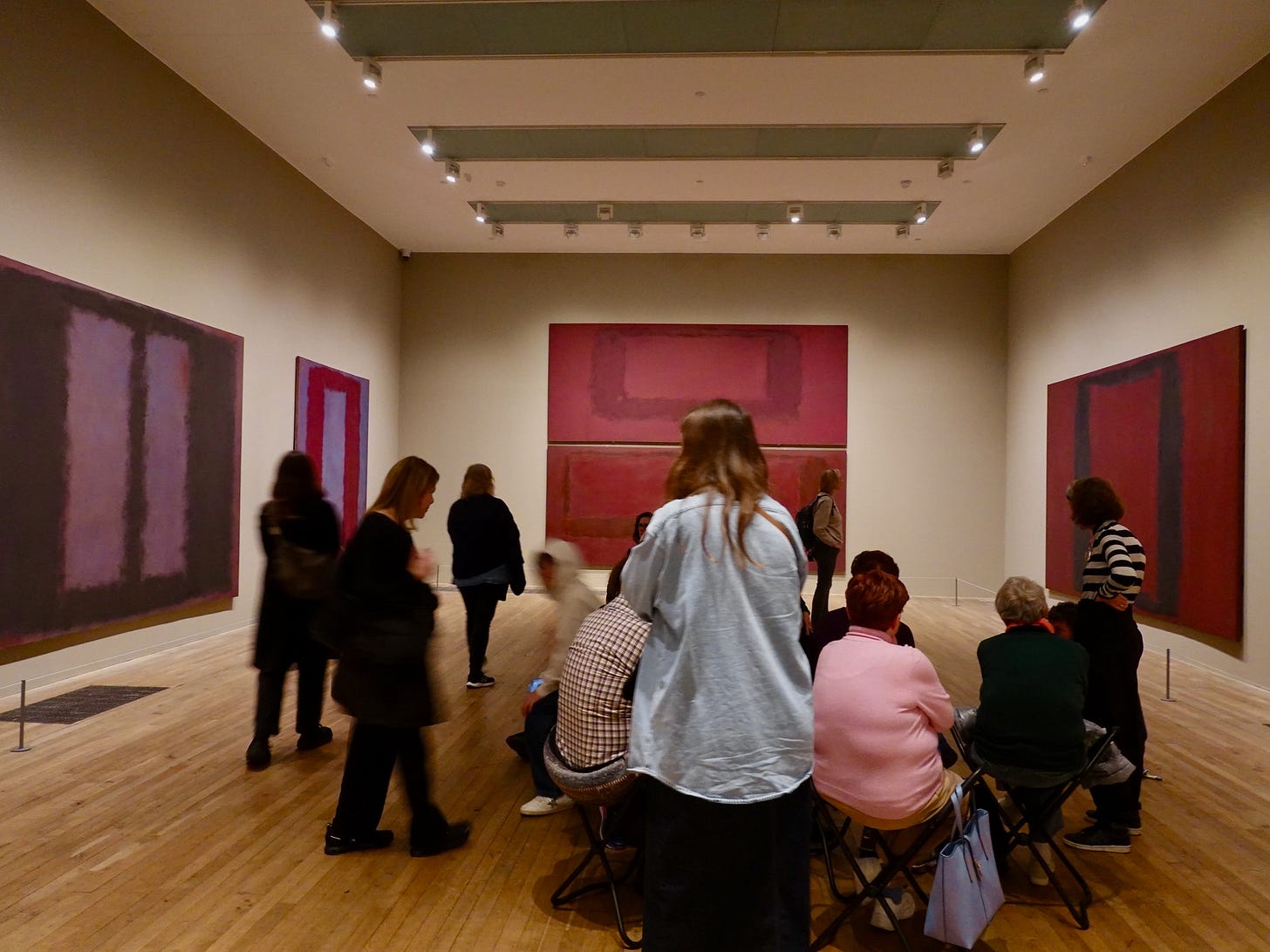 Visitors standing close to large Rothko canvases in the dedicated Rothko room at Tate Modern Visitors standing close to large Rothko canvases in the dedicated Rothko room at Tate Modern