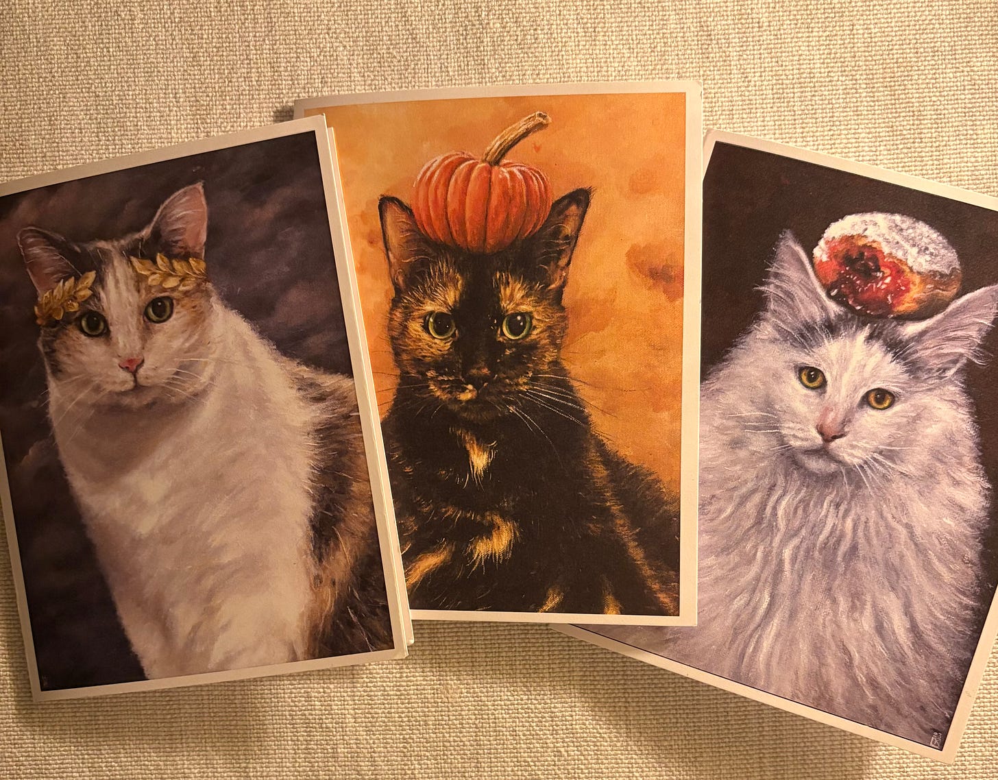 Three greeting cards with artwork depicting cats. Three greeting cards with artwork depicting cats.