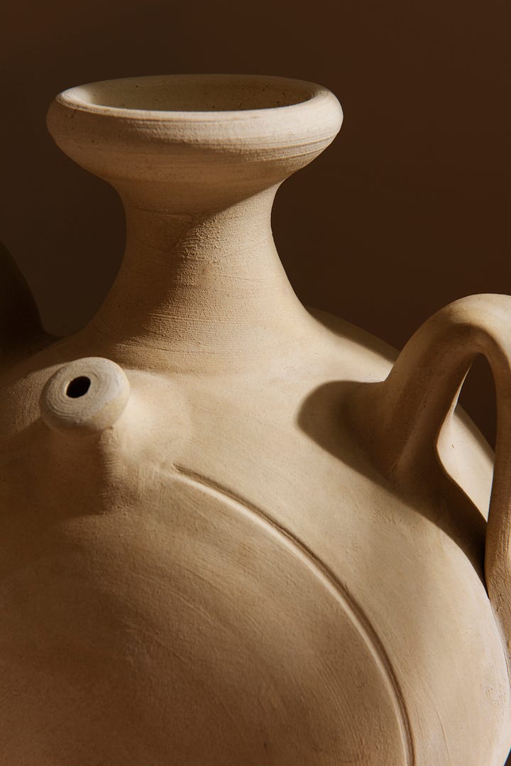 Close-up of a delicate dried flower petal, softly textured with fine, natural lines and subtle imperfections, representing the beauty of impermanence and Wabi-Sabi.Warmly lit close-up of a handcrafted ceramic vase, highlighting gentle curves, natural textures, and subtle irregularities, reflecting Wabi-Sabi’s appreciation for authenticity and imperfection.