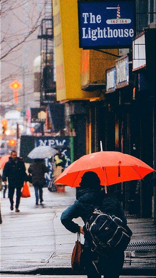 people walking on street beside high rise buildings