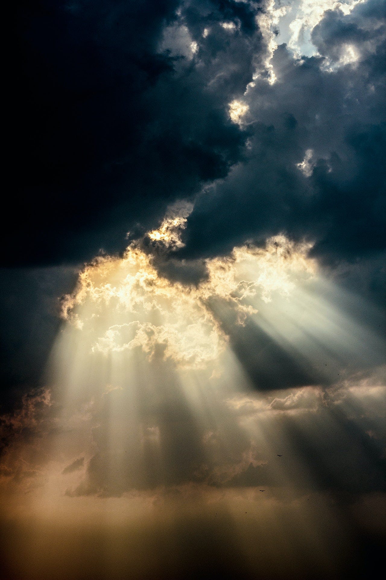 Sun breaking through storm clouds