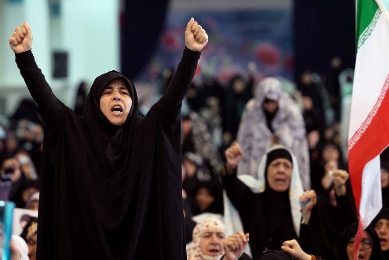 Iranian Shia women shout slogans during Eid al-Fitr prayers, marking the end of the Muslim holy month of Ramadan, at the Grand Mosalla mosque in Tehran on March 21.