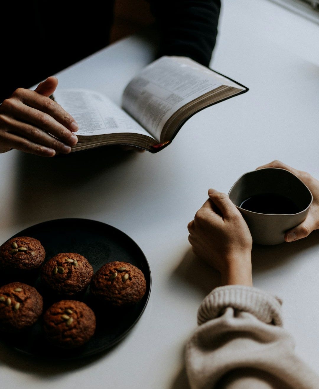person holding white ceramic mug with coffee