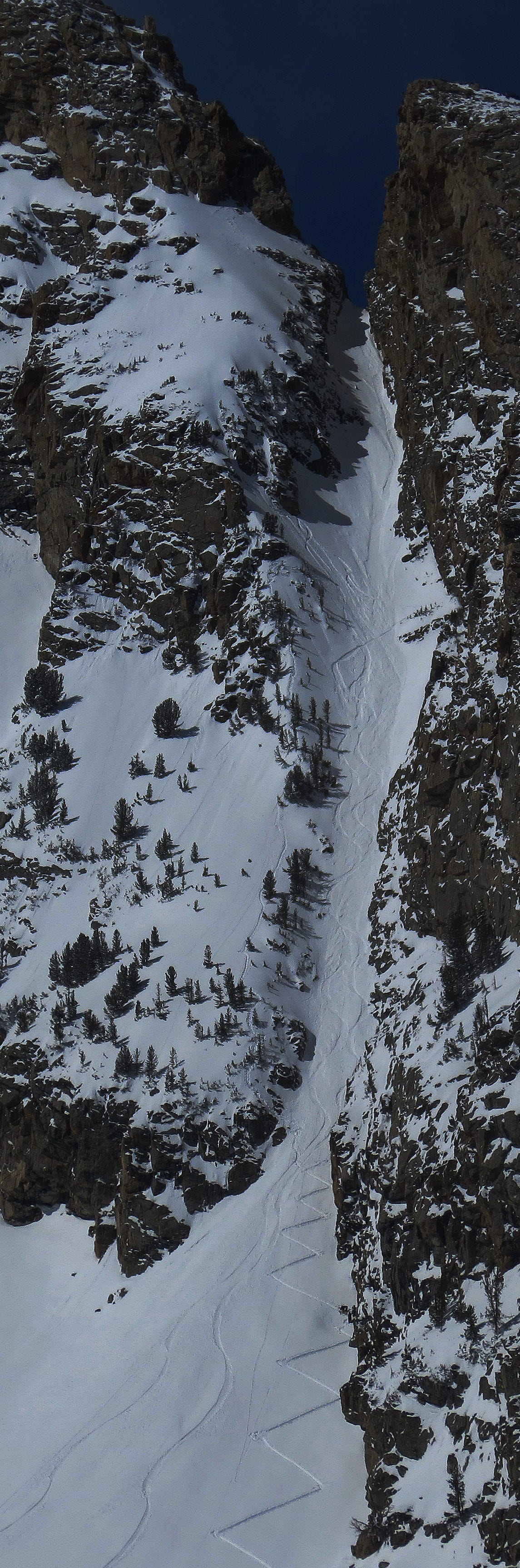 Bad ascent tracks made by two snowboarders are visible on the ridge to lookers' left of The Sliver, Nez Perce, GTNP.  Five additional snowboarders are visible at the 6th switchback gearing up to begin a mid-afternoon ascent on a warm, sunny  March 19th, 2014.  Detailed photos are included below.