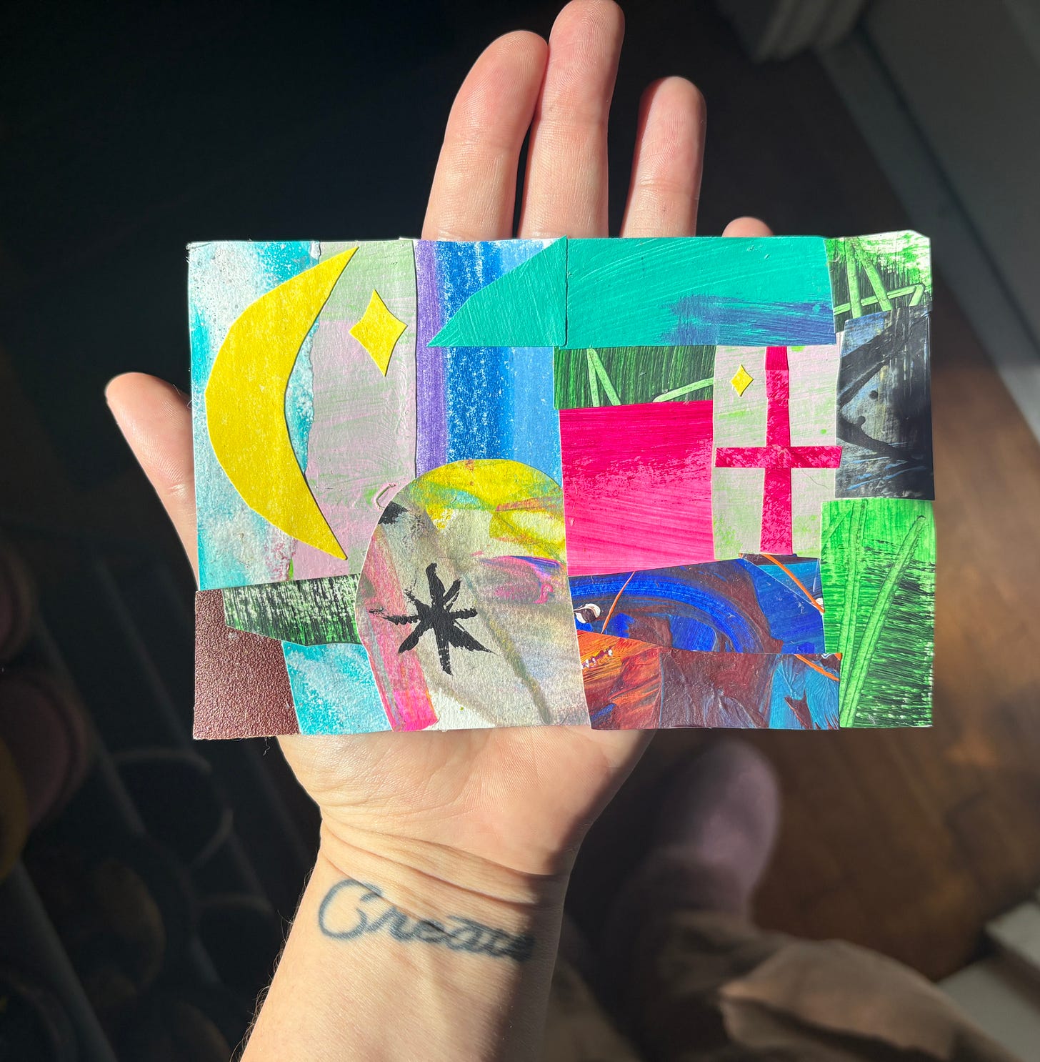 Shady holding their collaged postcard in their hand