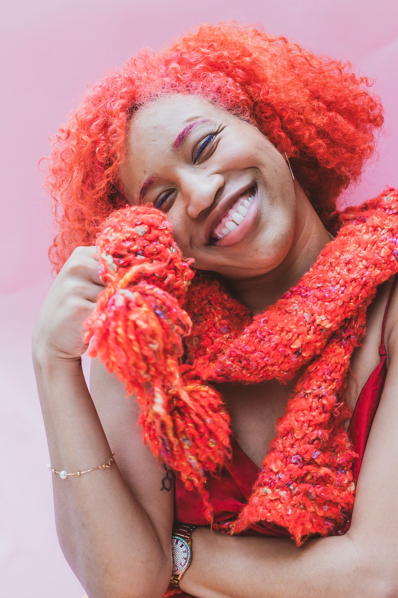 Kiana with a handknitted red scarf wrapped around her neck.