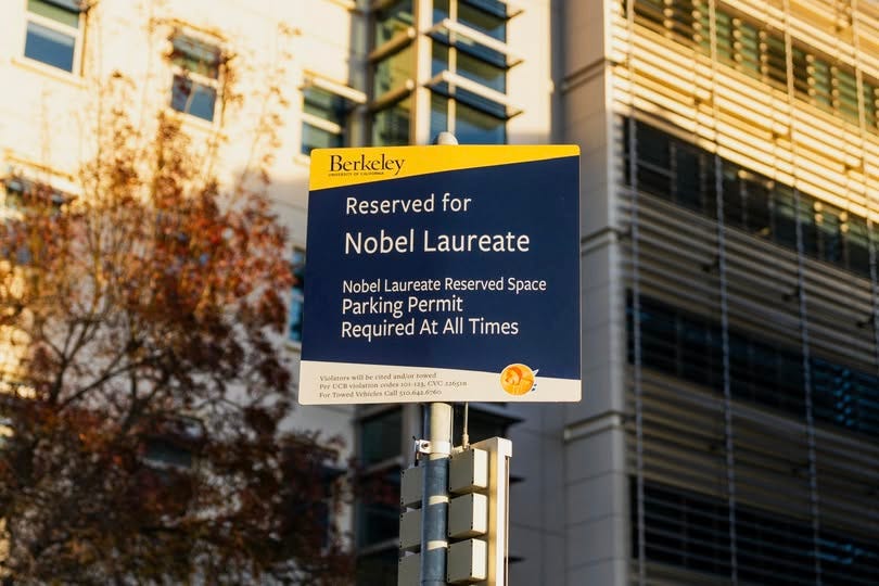 May be an image of text that says 'BNATMUTY Berkeley Reserved for Nobel Laureate Nobel Laureate Reserved Space Parking Permit Required At All Times Violators PerUCB UCB ا Towedl 3.CV 2265311 nadex For TRMCH 记山量 Vehteles Coll 10.642.6760' May be an image of text that says 'BNATMUTY Berkeley Reserved for Nobel Laureate Nobel Laureate Reserved Space Parking Permit Required At All Times Violators PerUCB UCB ا Towedl 3.CV 2265311 nadex For TRMCH 记山量 Vehteles Coll 10.642.6760'