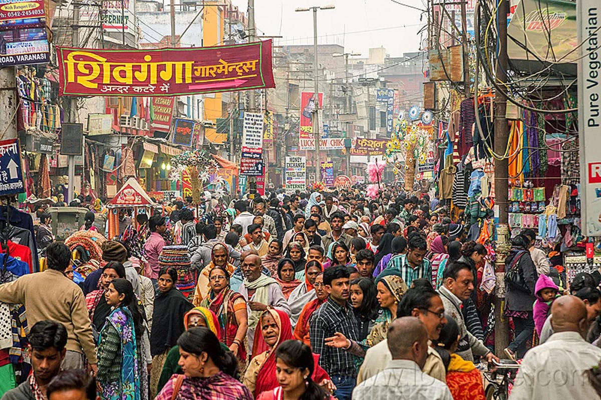 very crowded pedestrian market street, india