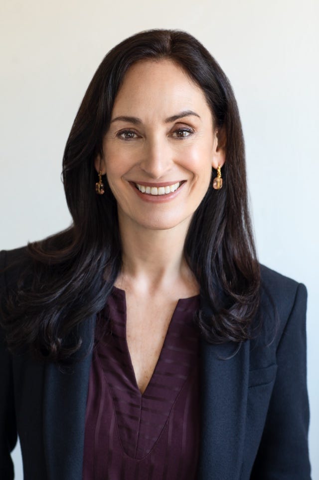 A person smiling for the camera

Description automatically generated with low confidence