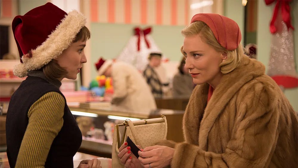 Rooney Mara in a Christmas hat serves Cate Blanchett in a depatrtment store Rooney Mara in a Christmas hat serves Cate Blanchett in a depatrtment store