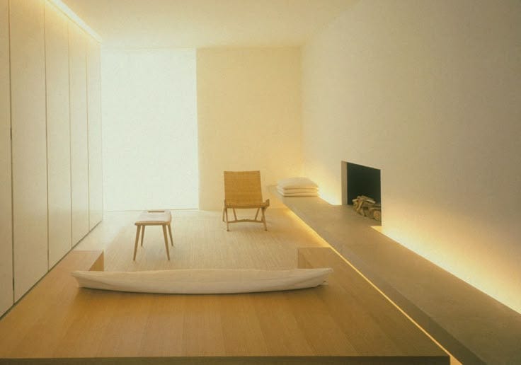 This may contain: an empty room with white walls and wooden floors