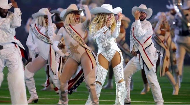 A group of people wearing cowboy hats and dancing on a field

Description automatically generated