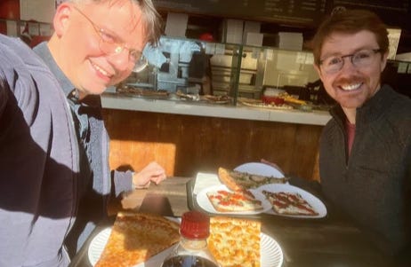 Michel and Martin eating pizza together. Michel and Martin eating pizza together.