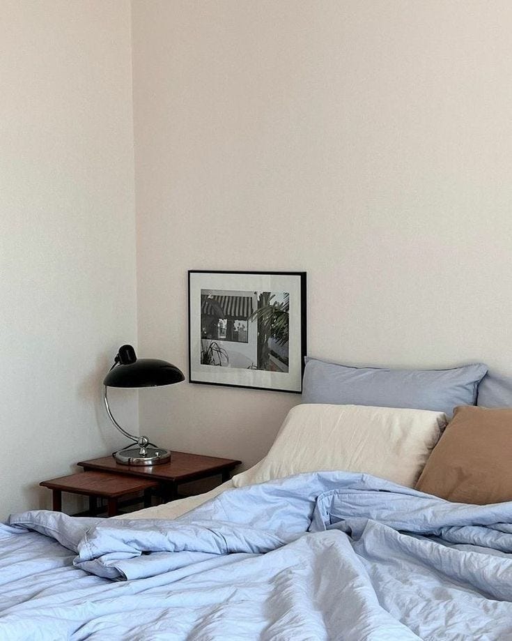 This may contain: an unmade bed with blue and white sheets in a bedroom next to a night stand This may contain: an unmade bed with blue and white sheets in a bedroom next to a night stand