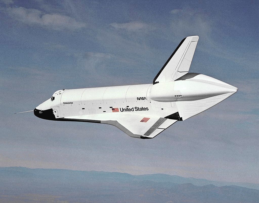 The Space Shuttle Enterprise glides freely through the sky during testing (1977). 