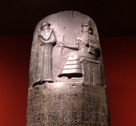 A stone sculpture of people

Description automatically generated