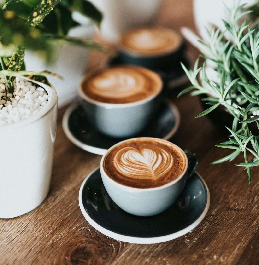 shallow focus photography of coffee late in mug on table