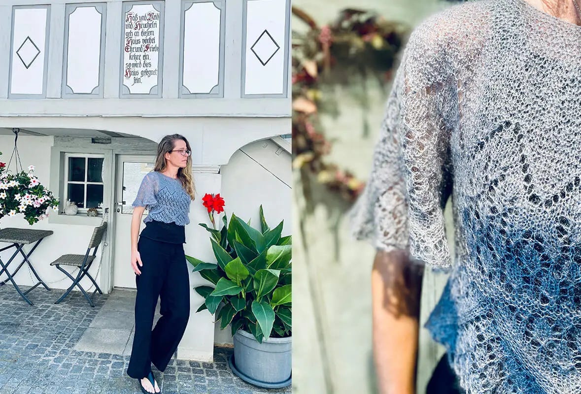 woman standing in front of building wearing lacy short sleeves sweater