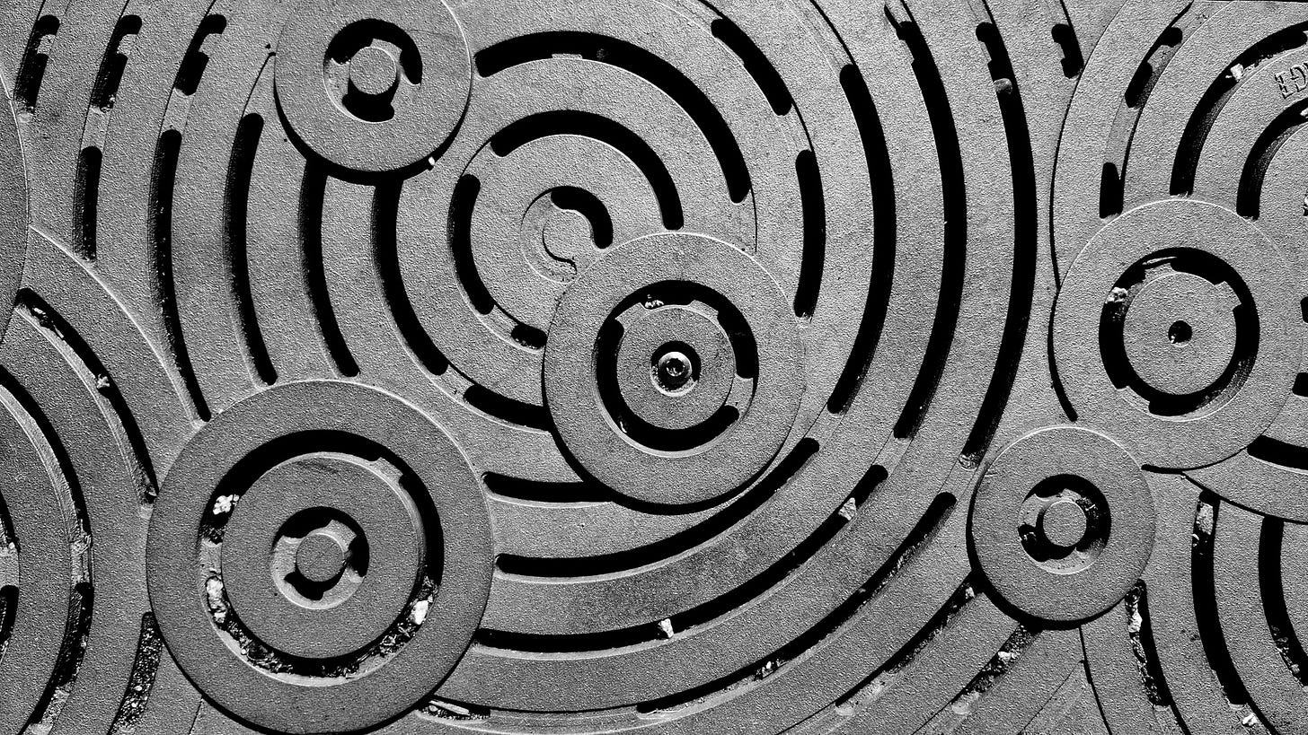 A black and white photo of a manhole cover