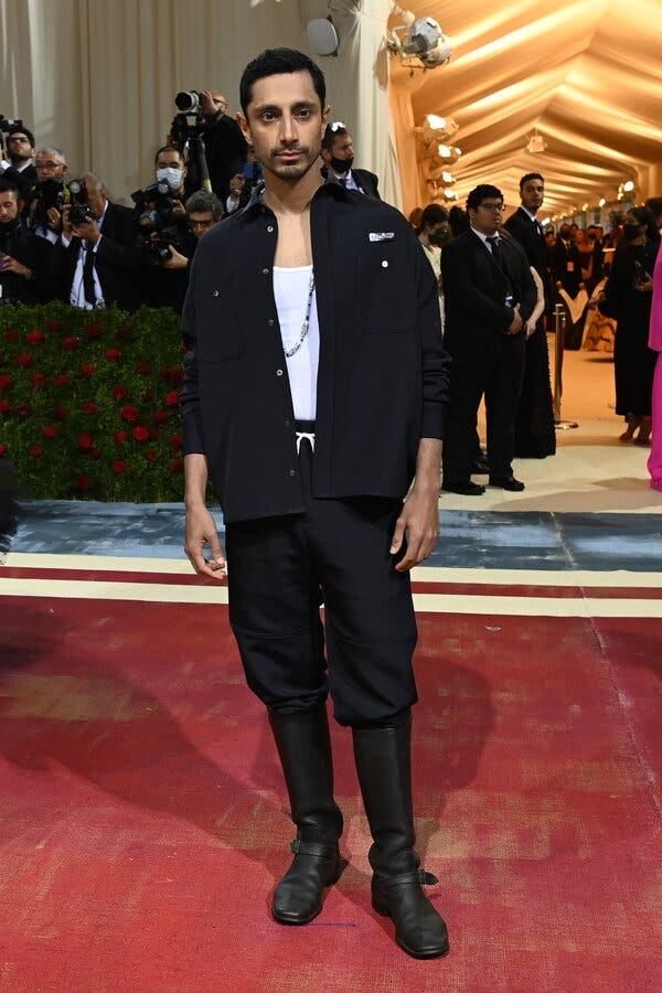 Riz Ahmed in white tie workwear.