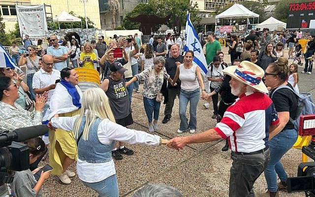 Israelis celebrate the announcement of a deal to free all hostages, end the war in Gaza at Hostages Square in Tel Aviv on October 9, 2025 (Ben Sales/Times of Israel)