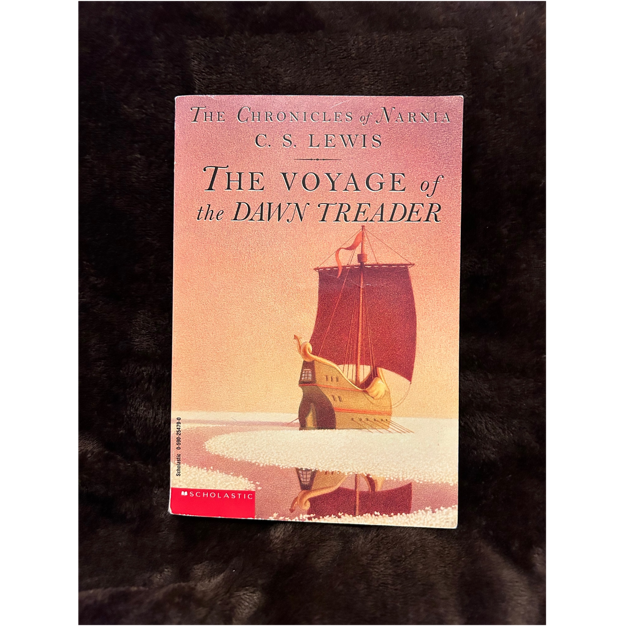 A book on a black surface

Description automatically generated