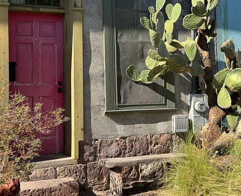 The photos display nine homes in the Sonoran architectural style traditional to the Southwest of the United States. The homes feature flat roofs, front walls that begin at the sidewalk's edge, colorful stucco exterior walls, and large windows.