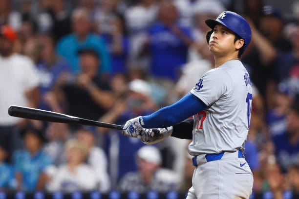 Shohei Ohtani of the Los Angeles Dodgers hits a two-run home run, his 50th of the season, during the seventh inning against the Miami Marlins at...