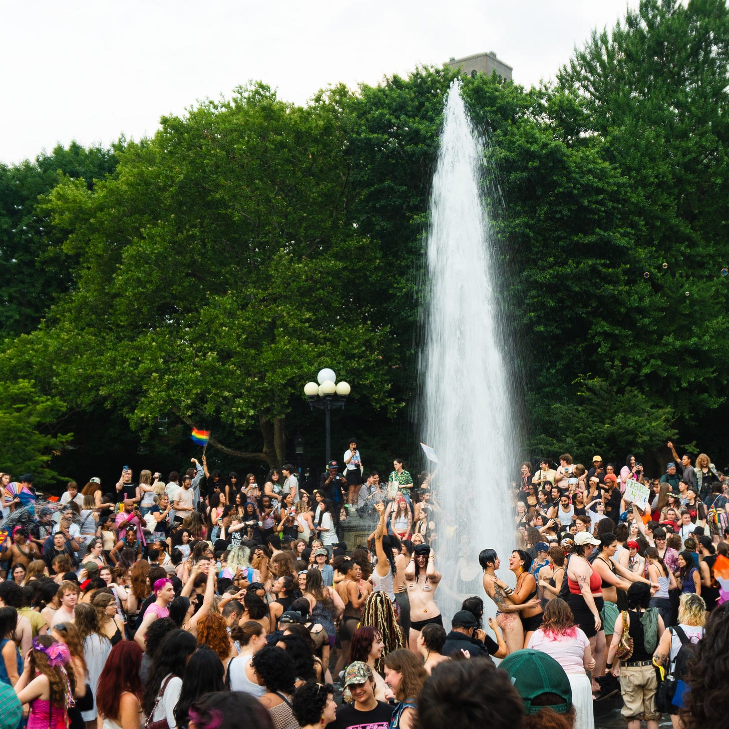 Queers dancing in the fountain.
