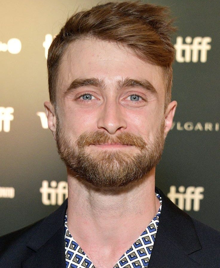 This may contain: a man with a beard wearing a suit and tie