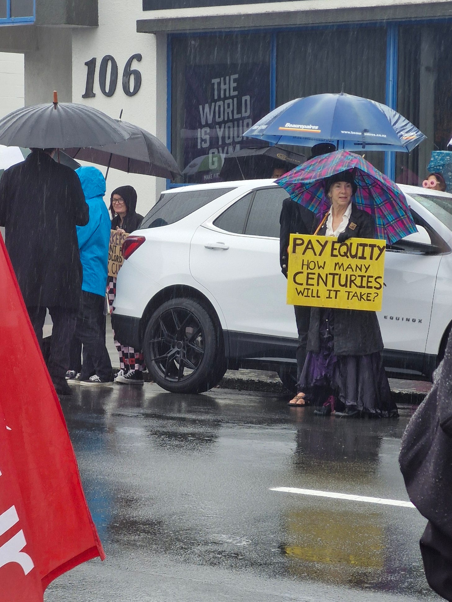 sign reads, pay equity how many centuries will it take?