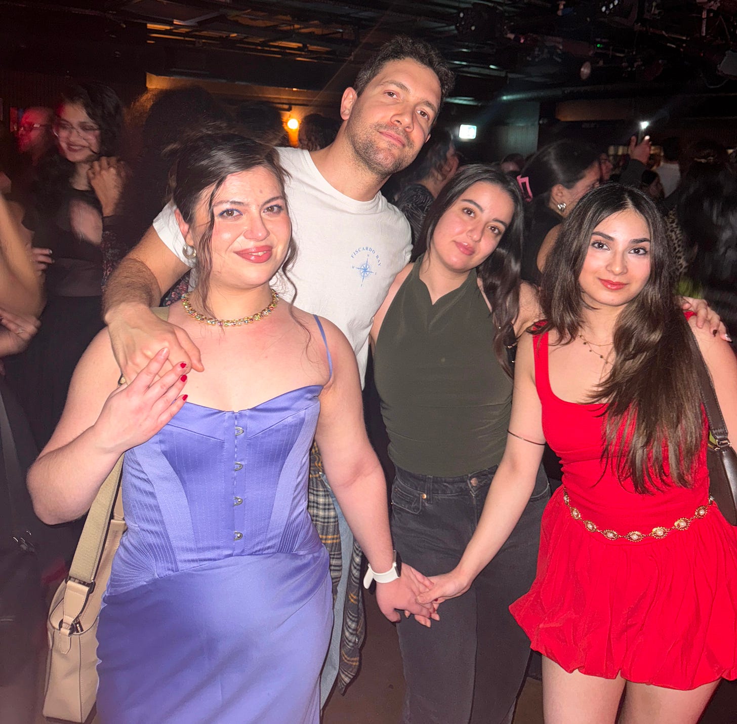 Sama and three of her friends embracing in a busy nightclub Sama and three of her friends embracing in a busy nightclub