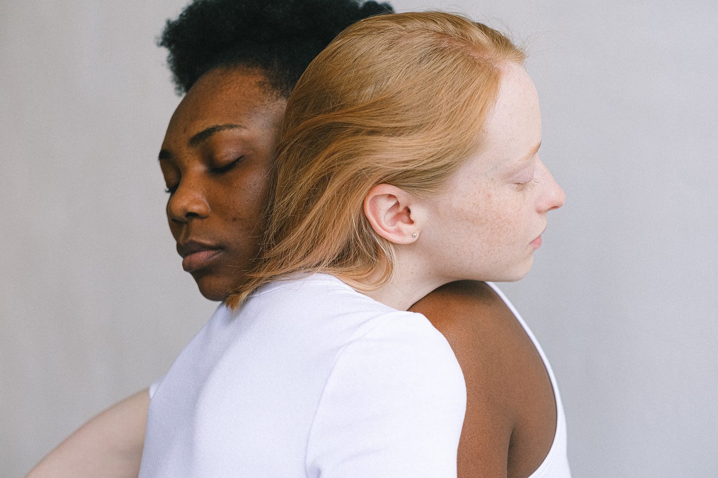 Black woman and white woman embracing Black woman and white woman embracing