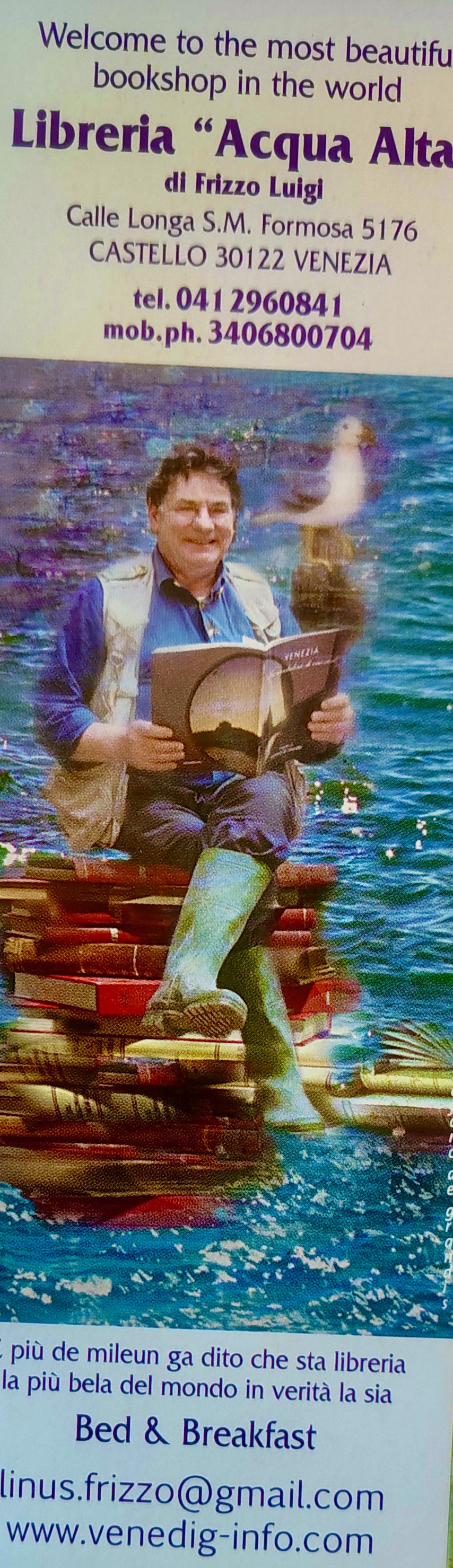 shows a man sitting on a stack of books surrounded by water
