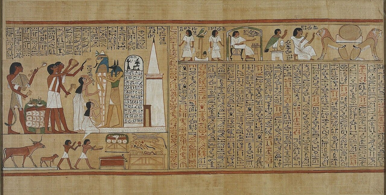 In front of a white tomb chapel topped with a small pyramid, a priest in a jackal mask holds a mummy upright while two women mourn and other priests raise ritual tools In front of a white tomb chapel topped with a small pyramid, a priest in a jackal mask holds a mummy upright while two women mourn and other priests raise ritual tools