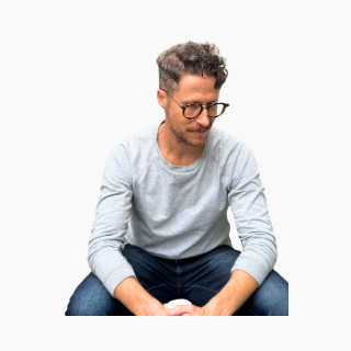 Author Stephen Belenky sitting thoughtfully, looking down, thinking "yeah, I'm working on this"