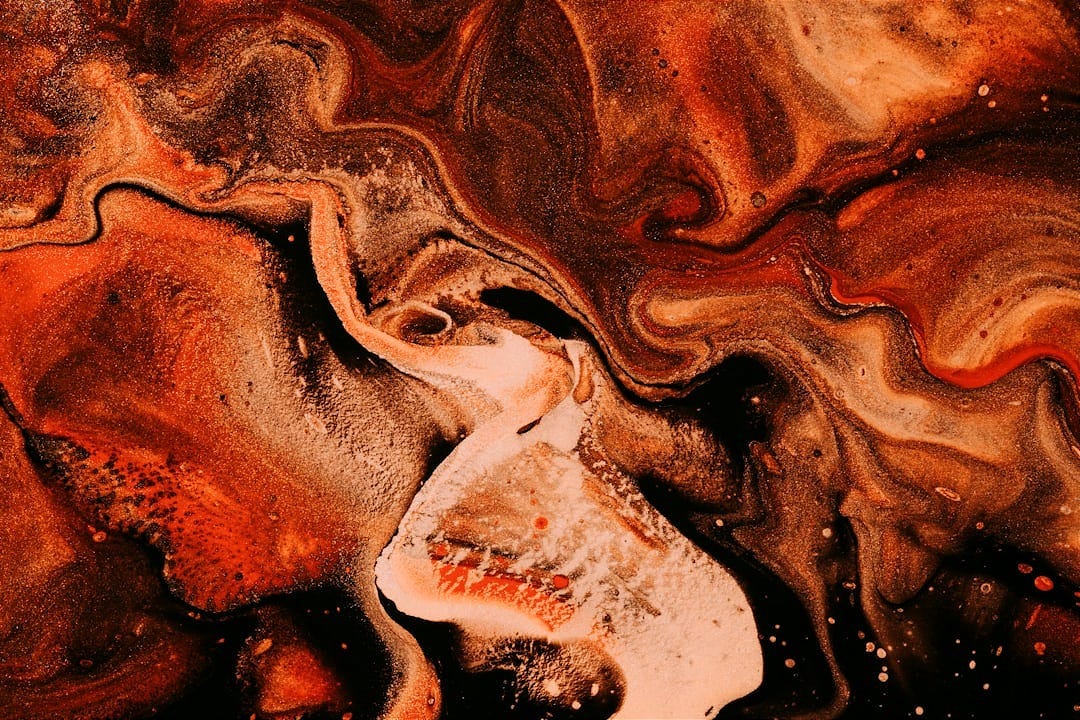 An abstract painting of molten light, with orange, beige, and whitish swirls. An abstract painting of molten light, with orange, beige, and whitish swirls.