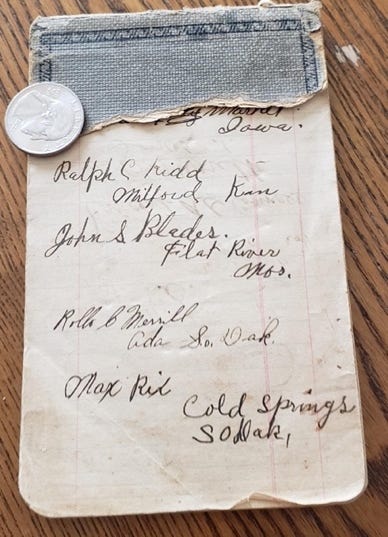 A piece of paper with a coin on it

Description automatically generated