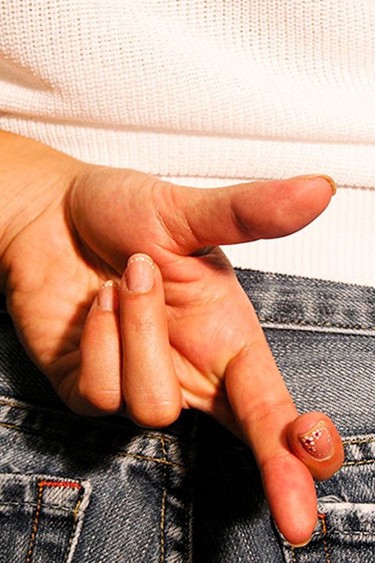 This may contain: a close up of a person's hand holding something in the back pocket of their jeans