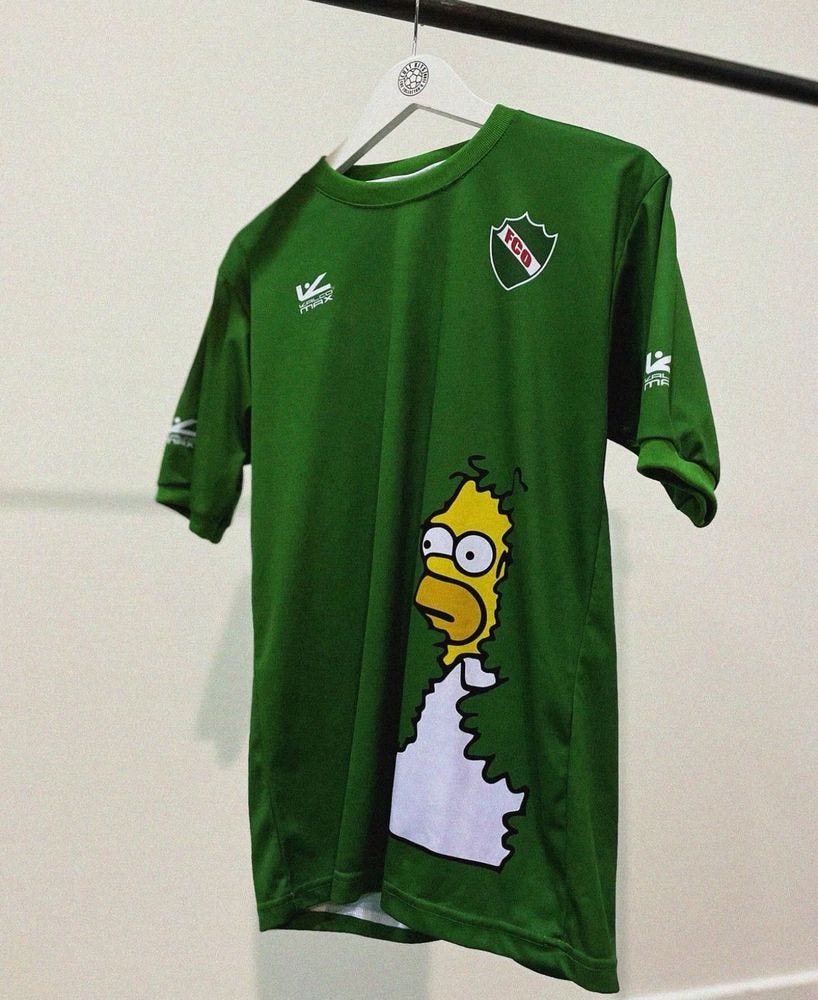 A football shirt featuring Homer Simpson disappearing into the bushes as per the popular meme 