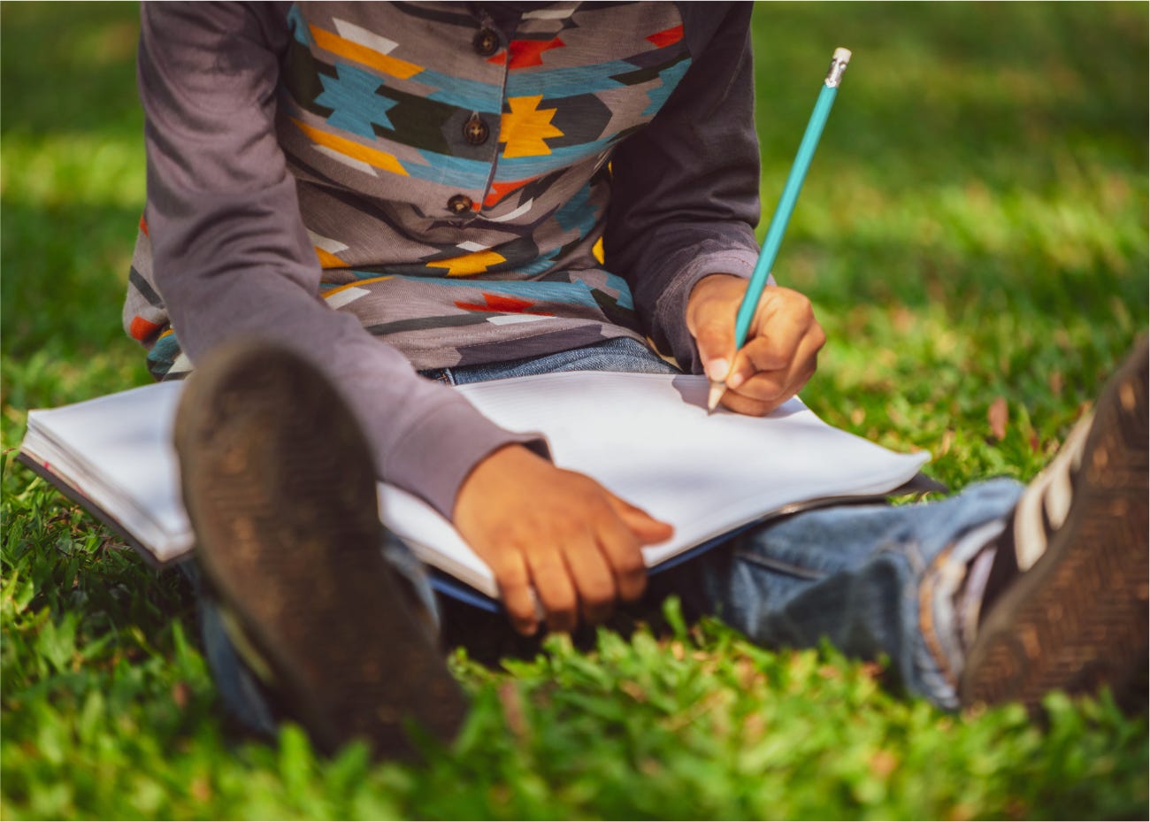 child writing outside child writing outside