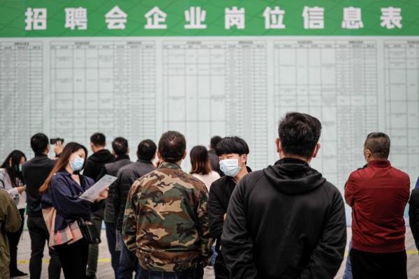 Job applicants read recruitment information at a job fair in Wuhan, Hubei Province, China, on April 21, 2020. (Getty Images) Job applicants read recruitment information at a job fair in Wuhan, Hubei Province, China, on April 21, 2020. (Getty Images)