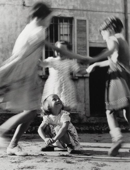 This may contain: black and white photograph of children playing outside