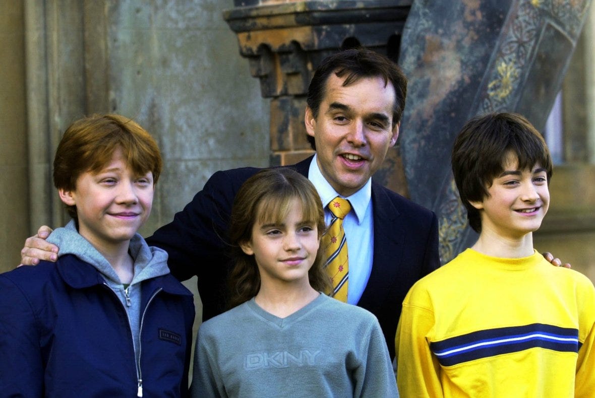 Daniel Radcliffe, Rupert Grint, Emma Watson, and director Chris Columbus at a photocall.